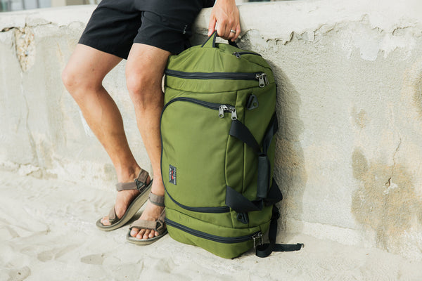 An Aeronaut 45 leaning against a wall on a sandy beach